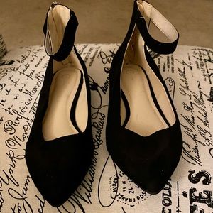 Black flats with ankle strap and zipper in the back.